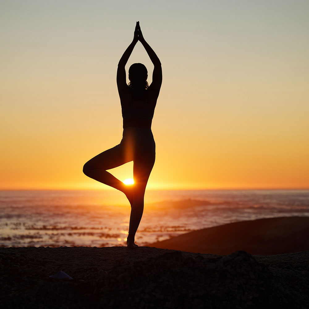 Woman, silhouette or sunset yoga on beach by ocean, sea or water horizon for mental health