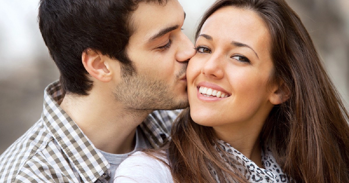 Man and woman couple smiling and kissing