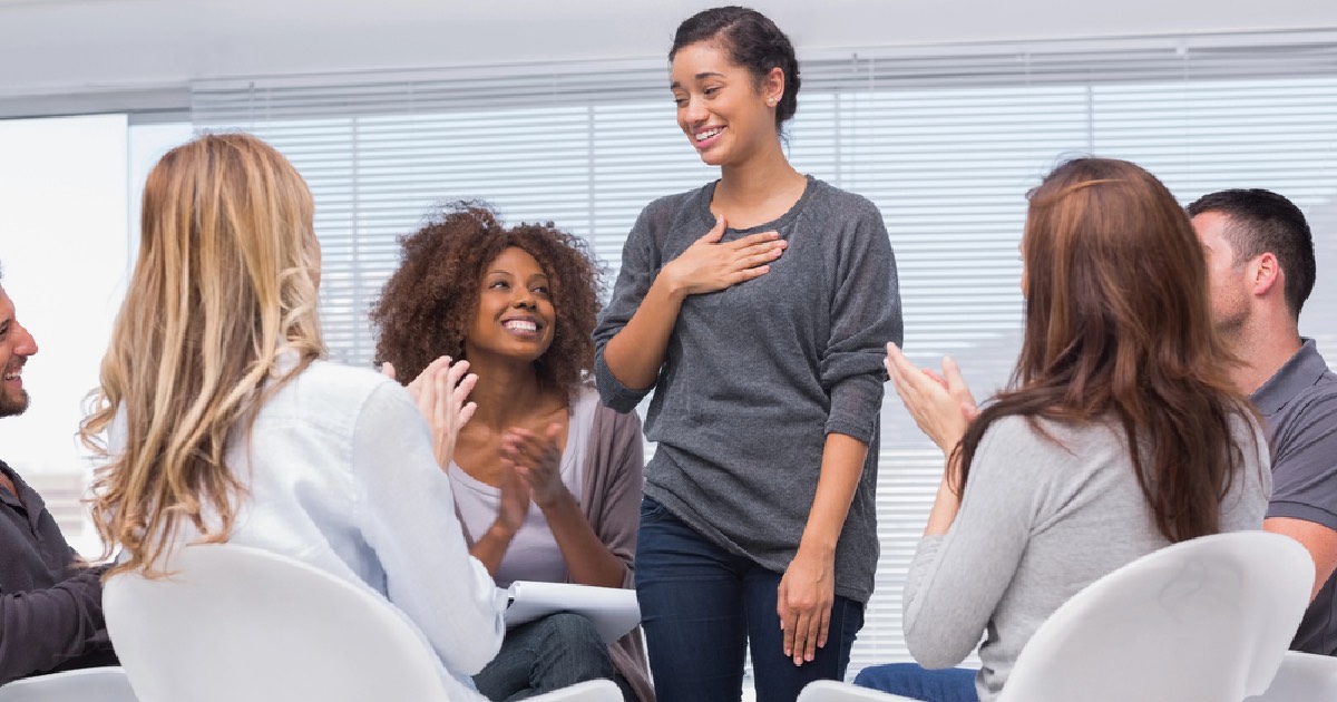 Woman celebrating accomplishments in 12-step group