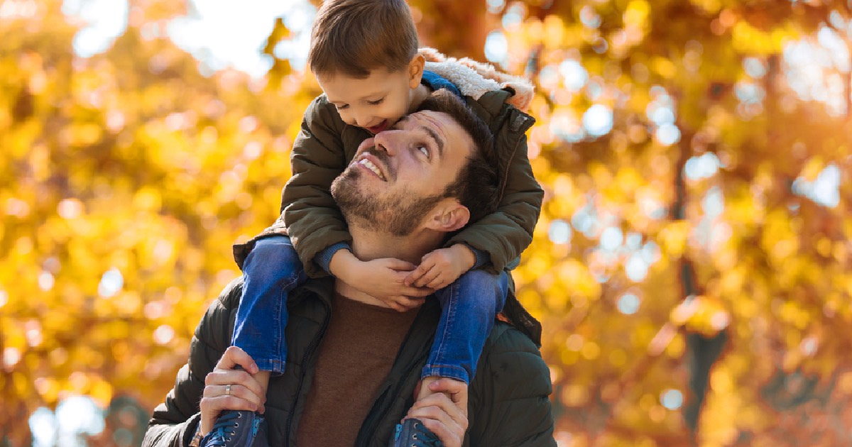 Dad with son outdoors on a beautiful fall day 