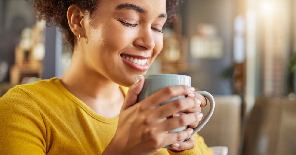 Woman drinking a cup of coffee with a positive mindset