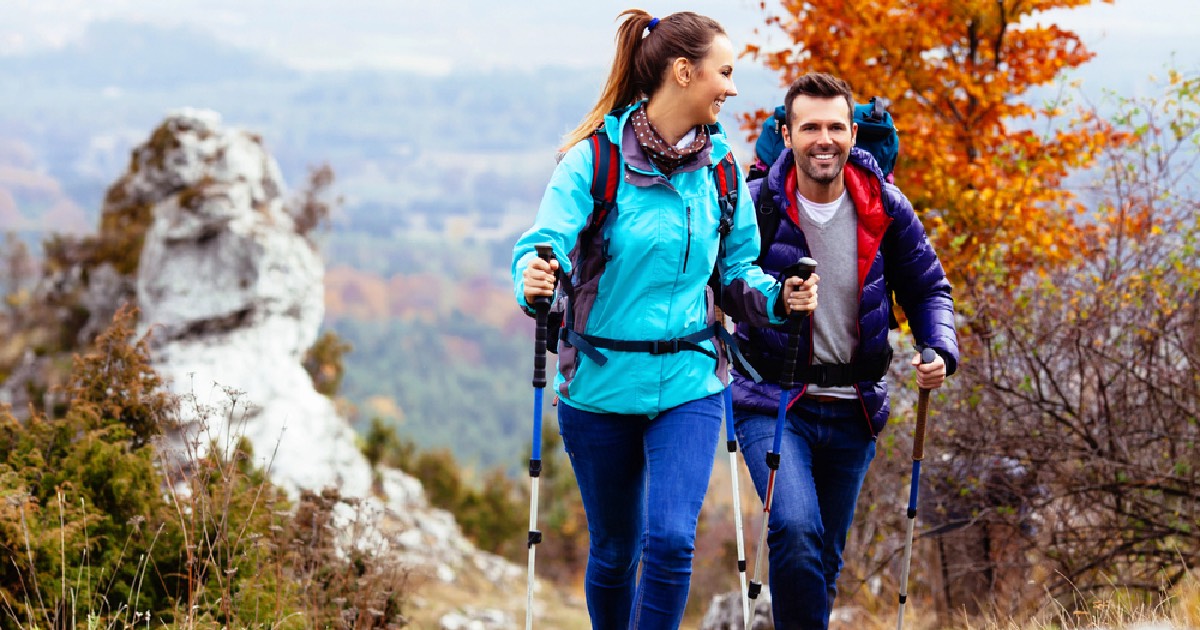 Couple hiking through mountains on a chilly fall day