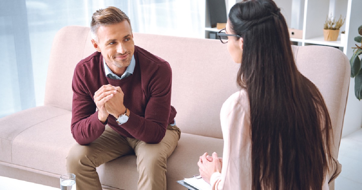 Man sitting on couch discussing antidepressants with therapist