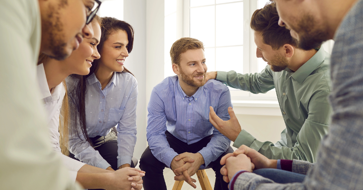 Group therapy session with supportive people